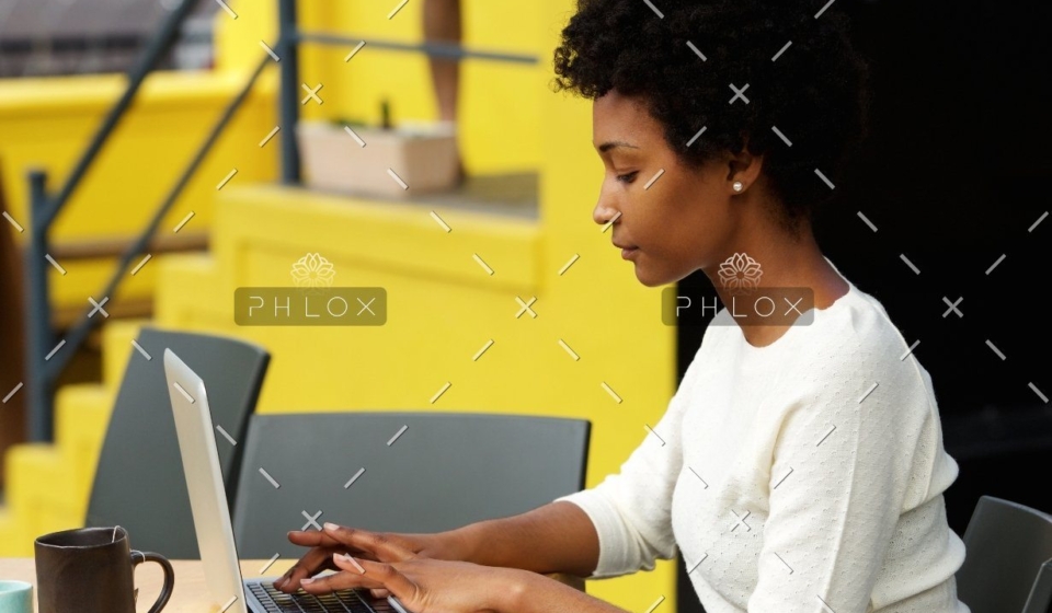 demo-attachment-1082-attractive-young-woman-using-laptop-outside-P9RLFGU@2x